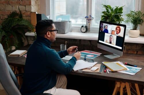 teacher-video-calling-with-his-students-using-a-computer