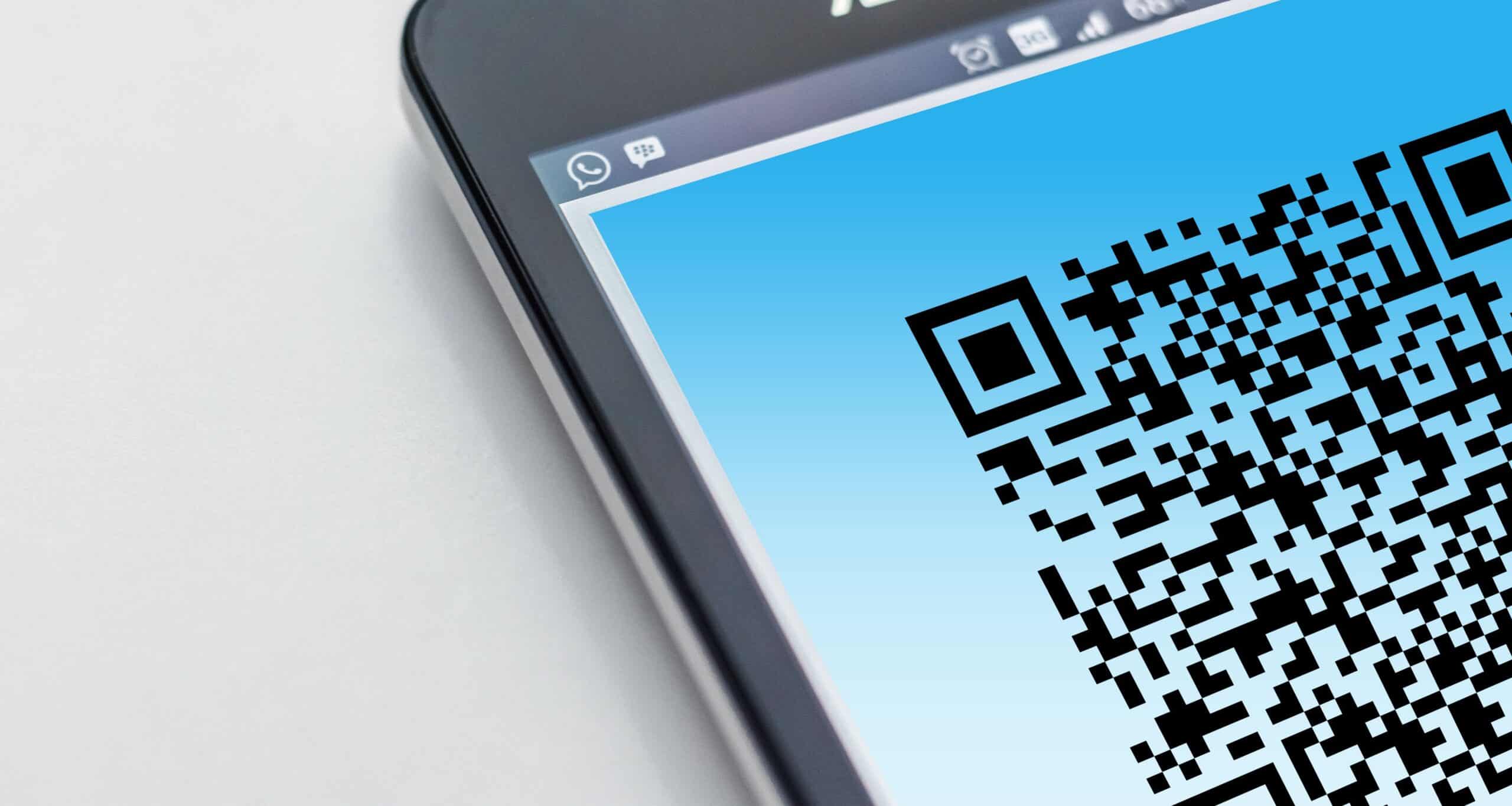Blog 6 Free High-resolution close-up of a smartphone displaying a QR code on its screen. Stock Photo